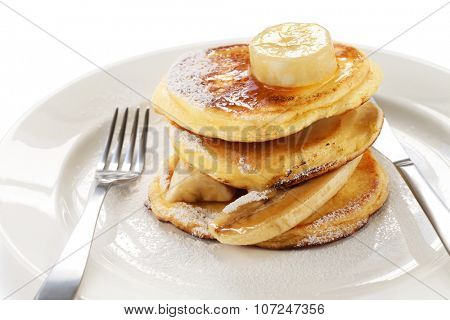 fluffy ricotta pancakes with banana isolated on white background