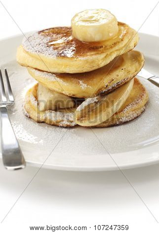 fluffy ricotta pancakes with banana isolated on white background