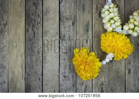 Marigold Flower Garland On Wood Plank, Top View