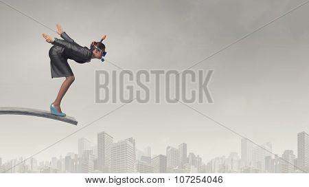 Young businesswoman in suit and diving mask jumping in water