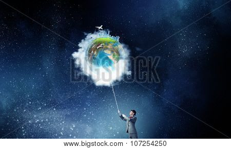 Businessman catch Earth planet with rope . Elements of this image are furnished by NASA