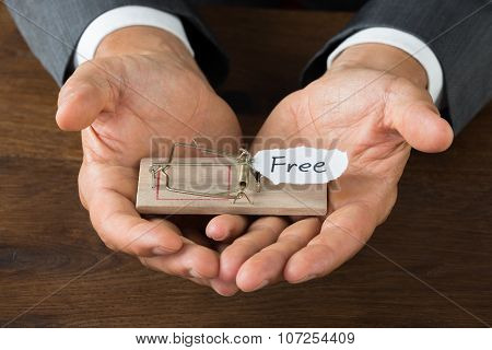 Businessman Holding Rattrap With Free Sign