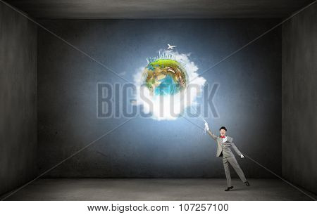 Businessman catch Earth planet with rope . Elements of this image are furnished by NASA