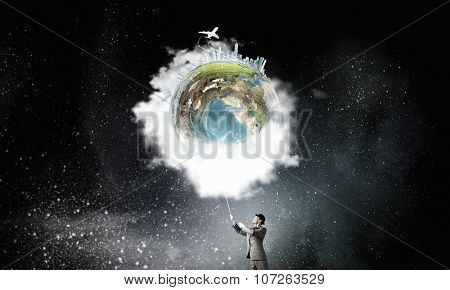 Businessman catch Earth planet with rope . Elements of this image are furnished by NASA