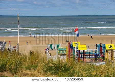 Tourists Walking Along The Sea Line In Zandvoort, The Netherlands