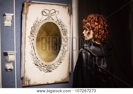 Very Pretty Woman Vamp Looking At Her Reflection In Mirror
