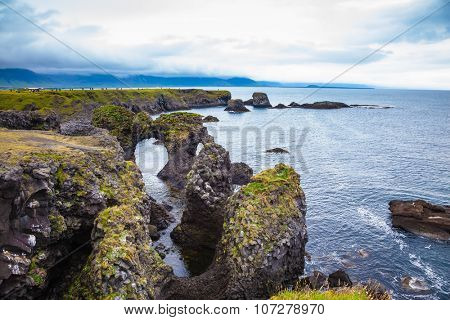 Magical coastal cliffs fishing village Arnastapi. July day in Iceland