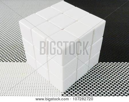 white cube on a black and white mat