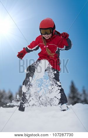 Young Girl Skier Plays With Snow