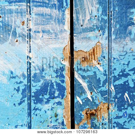 Stripped Paint In The Blue Wood Door And Rusty Nail
