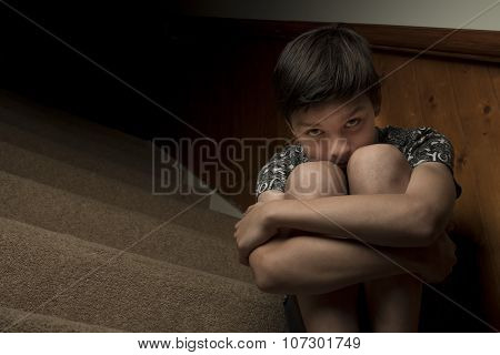 Sad Boy Sitting on Stairs