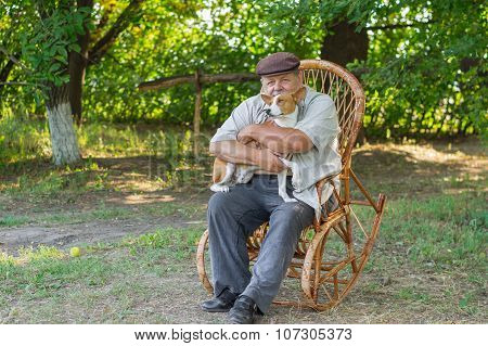 Young basenji sitting with master on a wicker chair