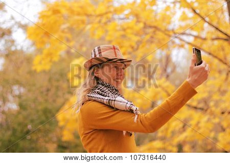 Girl Near Autumn Tree With Phone
