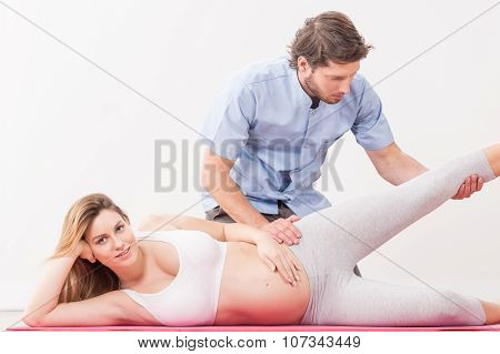 Pregnant Woman Exercising With Physiotherapist