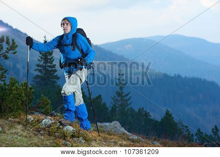 advanture man with backpack hiking on mountain forest