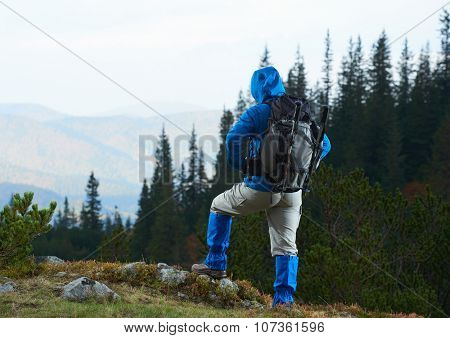 advanture man with backpack hiking on mountain forest