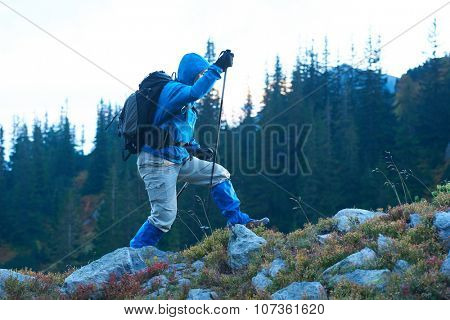 advanture man with backpack hiking on mountain forest