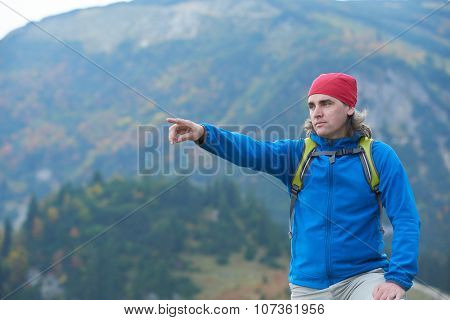 advanture man with backpack hiking on mountain forest