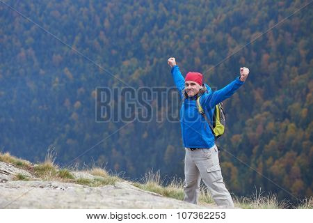 advanture man with backpack hiking on mountain forest