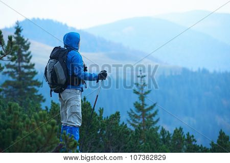 advanture man with backpack hiking on mountain forest