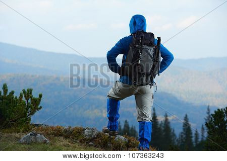 advanture man with backpack hiking on mountain forest