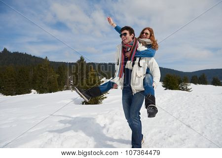 romantic winter  scene, happy young couple having fun on fresh show on winter vacatio, mountain nature landscape