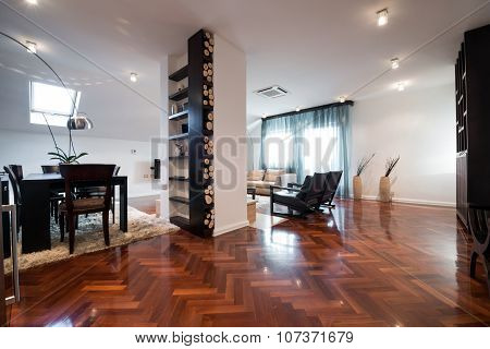 Interior Of A Spacious Living Room With Logs For Fireplace