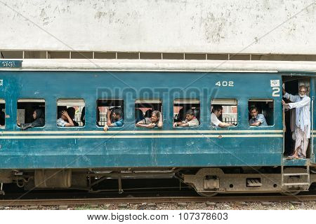 Commuters In Train Looking Through Window