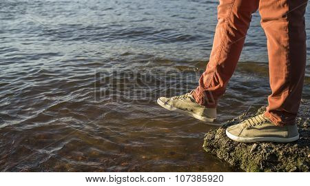 Close-up Of Legs Of A Man Who Takes A Step Into The River