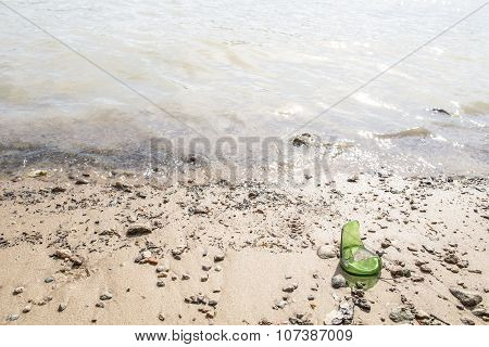 Broken Bottle Of Sharp Edged Lying On The Beach