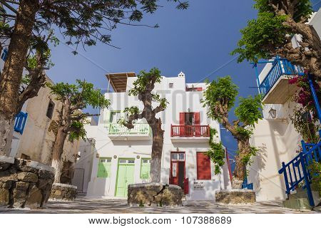 Small square of at Mykonos town with clear blue sky and trees, Greece