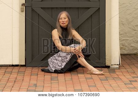 Woman Rests By Locked Door