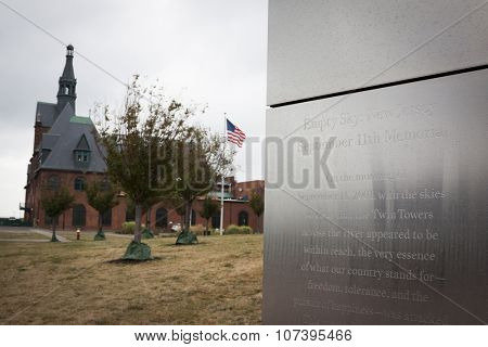 JERSEY CITY, NJ-SEP 10 2015: Empty Sky, the official New Jersey Sept 11th memorial with the historic Central Railroad of New Jersey Terminal building (CRRNJ) in the background in Liberty State Park.