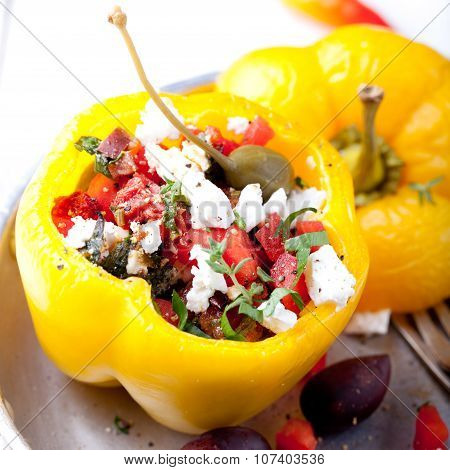 Baked stuffed bell peppers filled with cheese, capers and anchovies