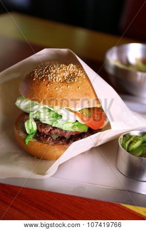 Sandwich and tinned cucumbers on a metal tray closeup