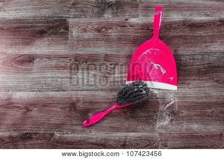 Small Whisk Broom And Dustpan On Wooden Floor