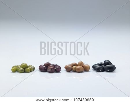 assorted beans arranged in a row