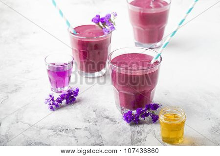 Blueberry, blackberry, honeysuckle, honeyberry smoothie with violet syrup and acai.
