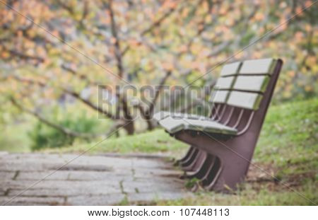 Blurred wood beanch and autumn park Abstract nature background