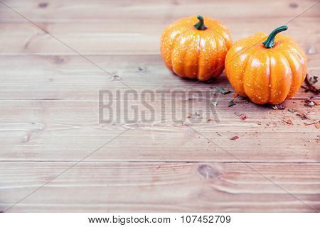 Pumpkin ornaments on desk with pot pourri