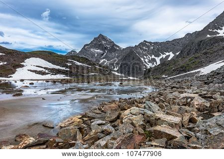 Rocks, Water And Alluvial Sand In A Small Mountain Valley