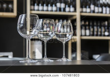 Glasses Of Wine On Counter And Bar On Background