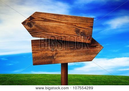 Blank Rustic Opposite Direction Wooden Sign On Grassland Field
