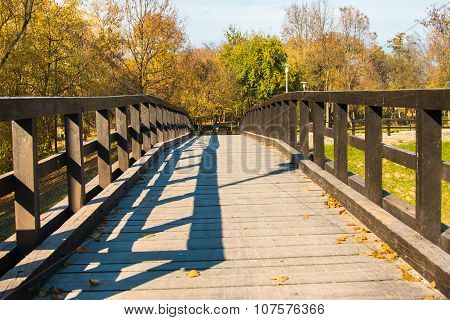 Wooden pedestrian bridge on Bundek lake in Zagreb, Croatia, in autumn