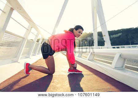 Athletic woman resting after fitness training outdoors during recreation time