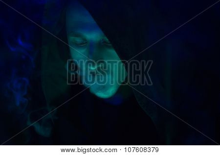 Club Party - Nightlife. Handsome Sexy Young Stylish Man In A Black Hood Smoking
