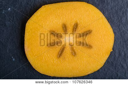 Slice Of Hurma Fruit On Black Background