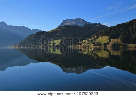 Mountains And Forest Reflecting In Lake Wagital