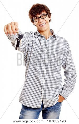Young hispanic man wearing checkered shirt, blue jeans and black glasses holding out car keys and smiling isolated on white background - new drivers concept