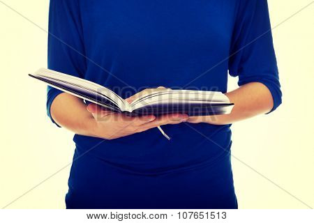 Young caucasian woman reading a book.